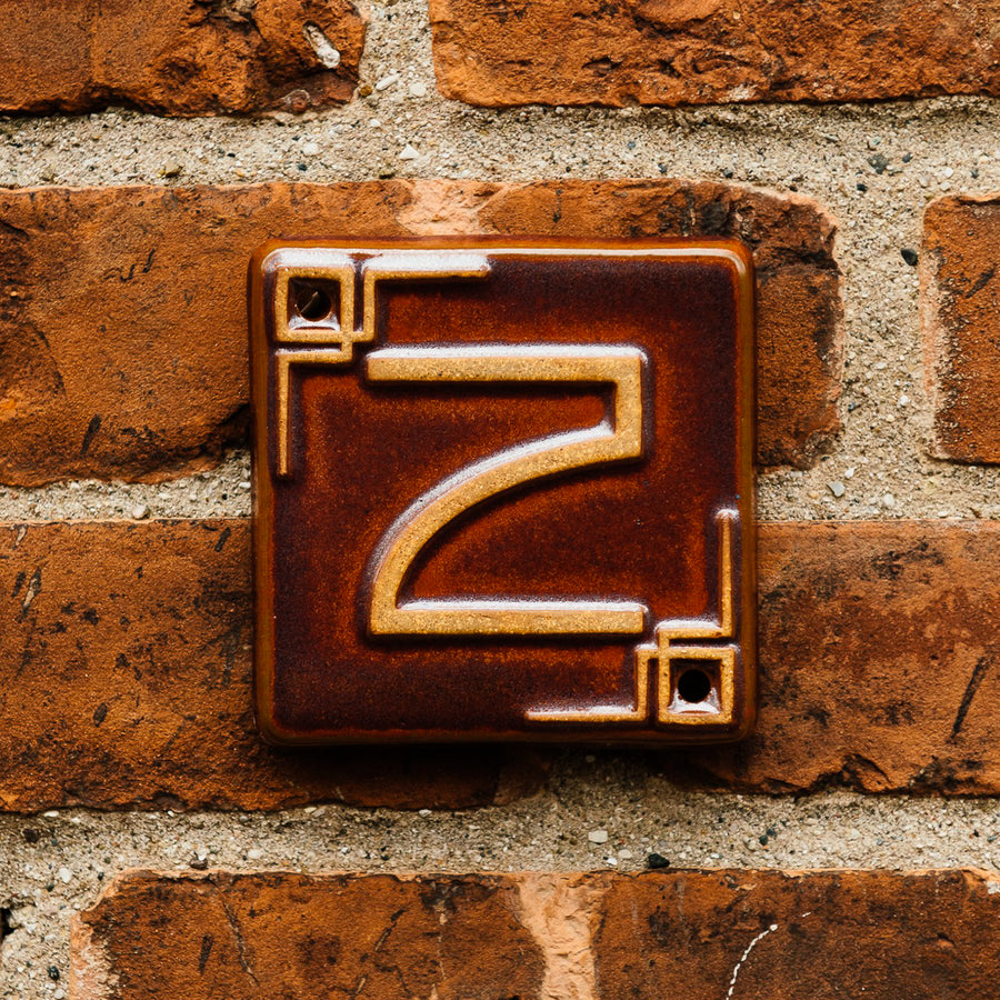 The Craftsman style ceramic 2 address number is in the satin reddish brown Carmine glaze option.