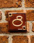 The Craftsman style ceramic 8 address number is in the satin reddish brown Carmine glaze option.