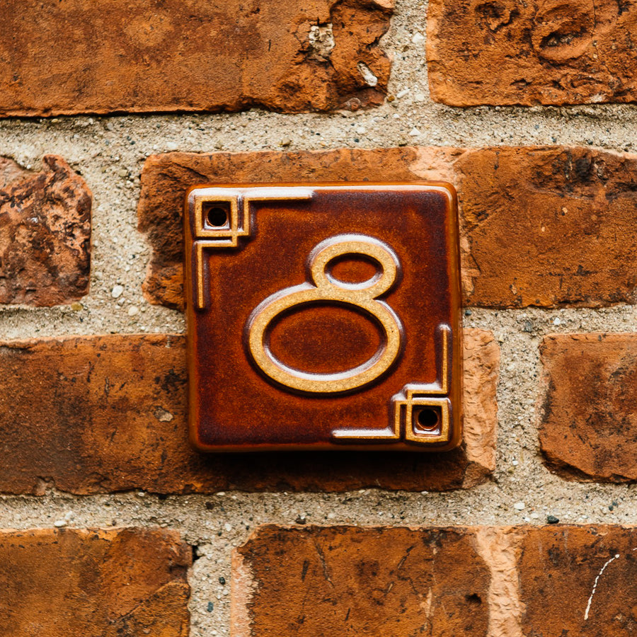 The Craftsman style ceramic 8 address number is in the satin reddish brown Carmine glaze option.