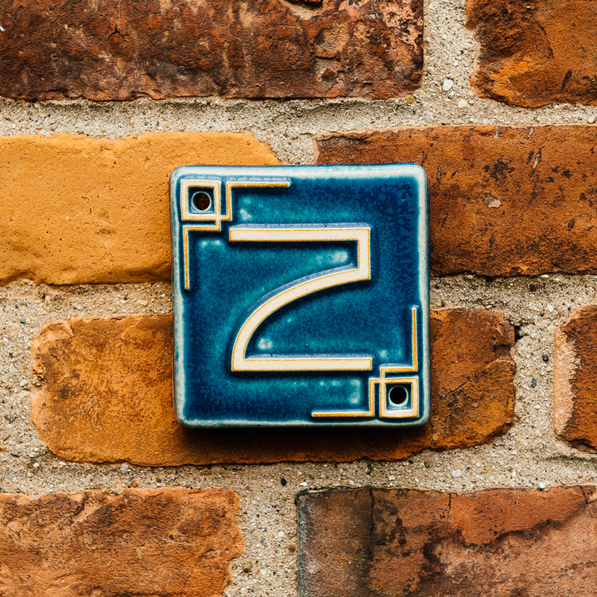 The Craftsman style ceramic 2 address number is in the matte blue Peacock glaze option.