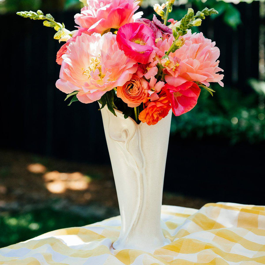 In the sun, the Calla Lily Vase in Birch glaze shows off the high relief design of the calla lily flower on its surface.