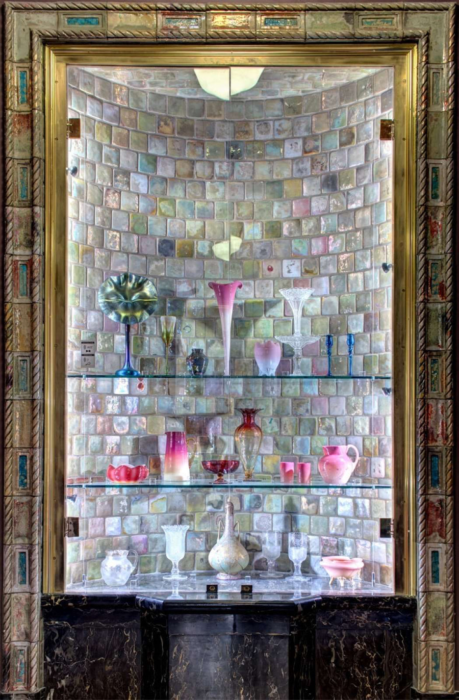 Around the alcove, colorful iridescent tiles border the outside.