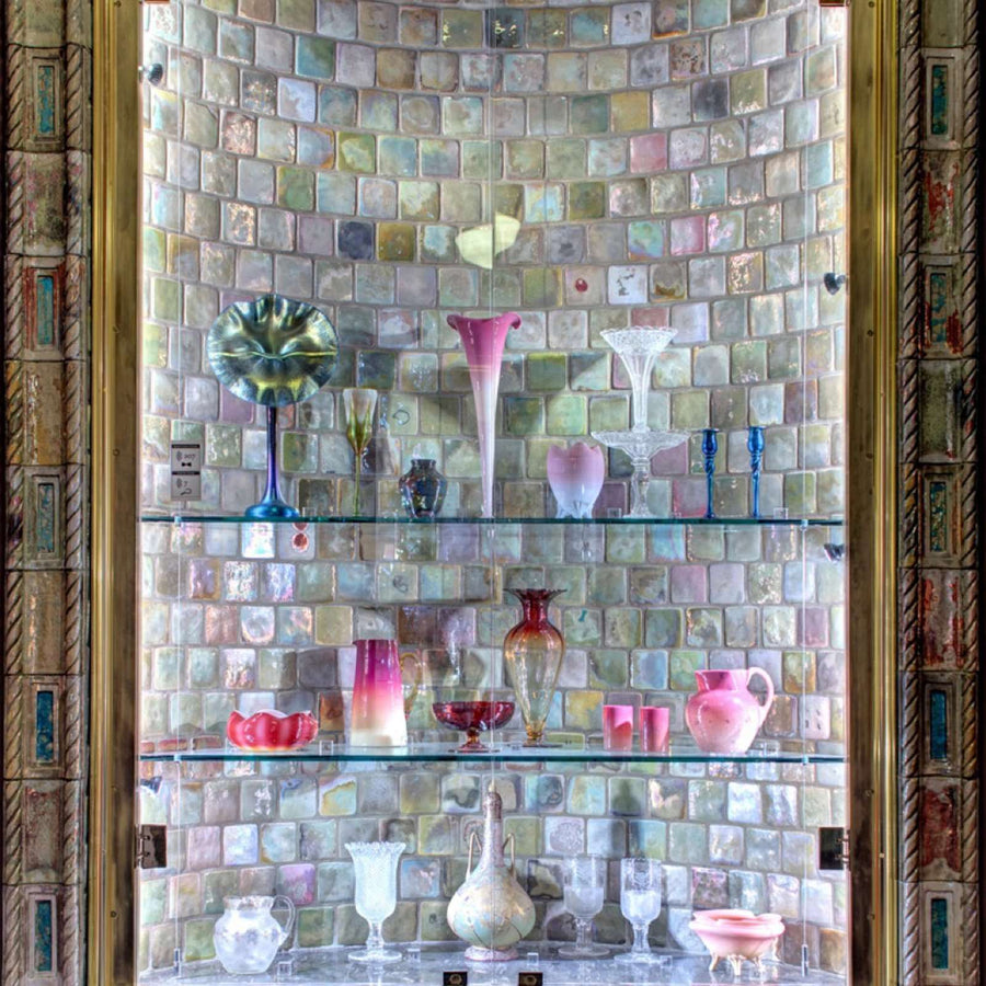 A shelved alcove boasts golden iridescent tiles.