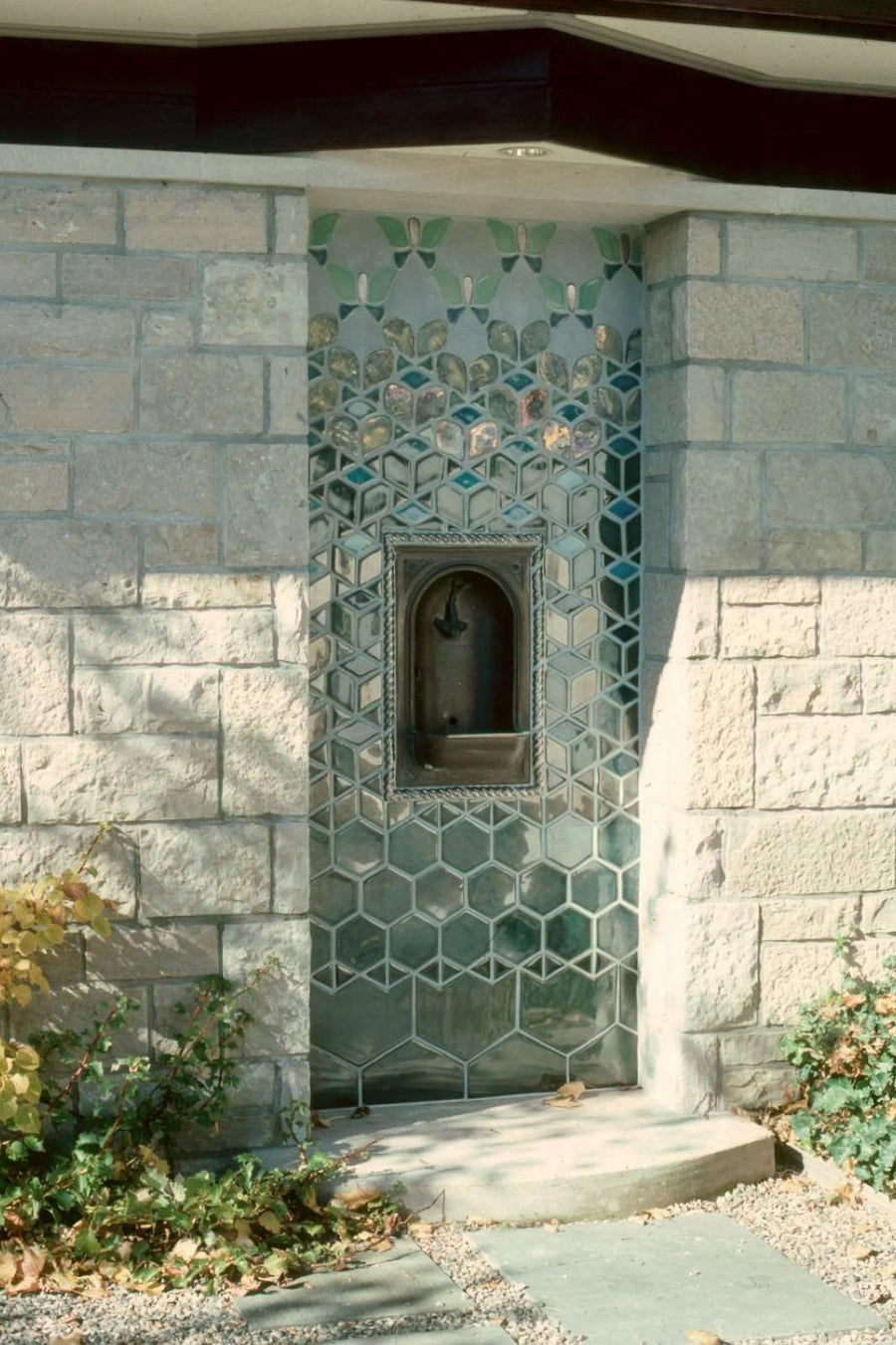 In the center of the design is a metal alcove where water can come out to fill water bottles. 
