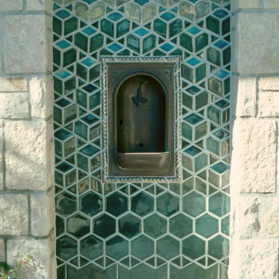 The glossy green Escher Fountain features an almost impossible design. The tiles at the bottom of the fountain are hexagonal and as they move up the wall become three sided cube-looking design. 