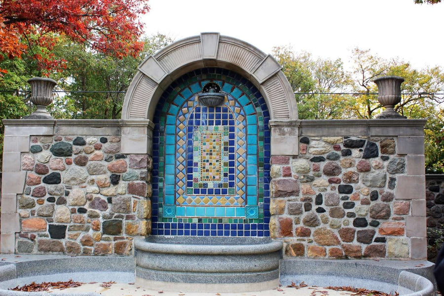 Near the top of the design rests a half bowl where water overflows into the large stone basin below.