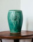The Pewabic Green vase sits on a round side table.