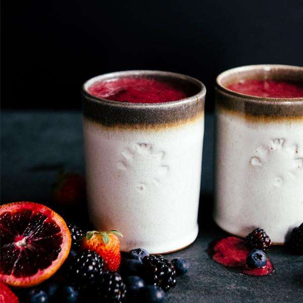 Two Rocks Cups hold a bright pink smoothie.