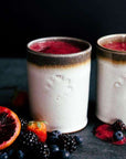 Two Rocks Cups hold a bright pink smoothie.