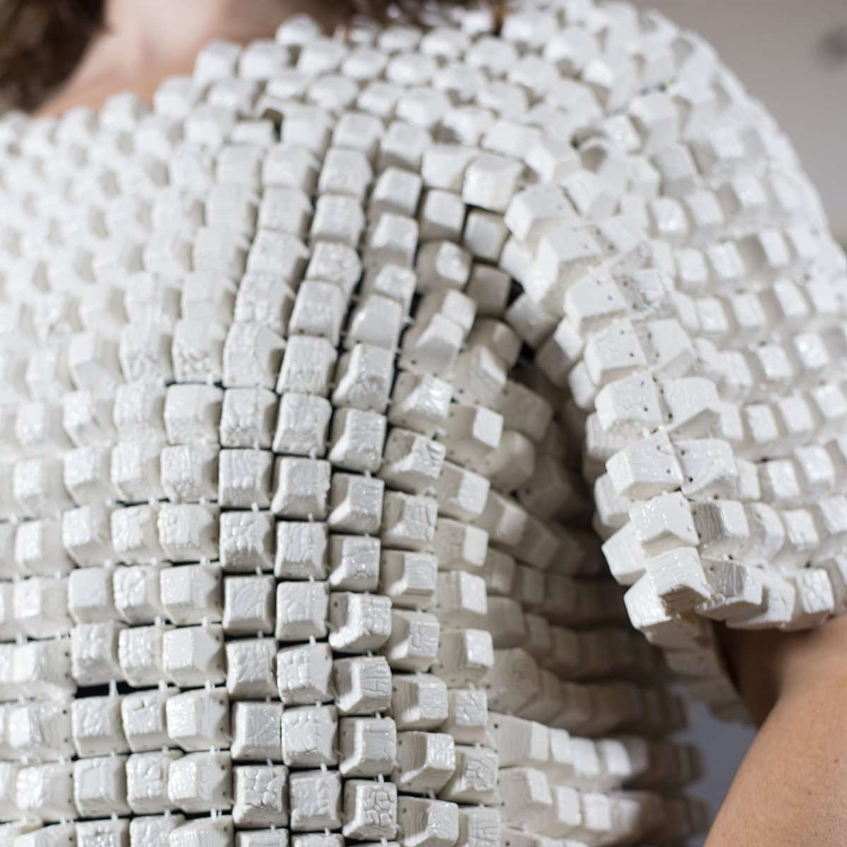 The art piece is worn by a woman.