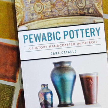 The Pewabic Pottery Book's cover features images of three ceramic vessels at the bottom and a historic Pewabic mural found at the Detroit Public Library at the top.