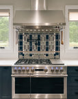 A custom kitchen backsplash prominently featuring glossy blue tiles that match the tone of the royal blue cabinetry.