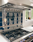 Side view of a custom kitchen backsplash prominently featuring glossy blue tiles alongside a blend of glossy grey tiles and matte finished tiles in an intricate geometric formation.