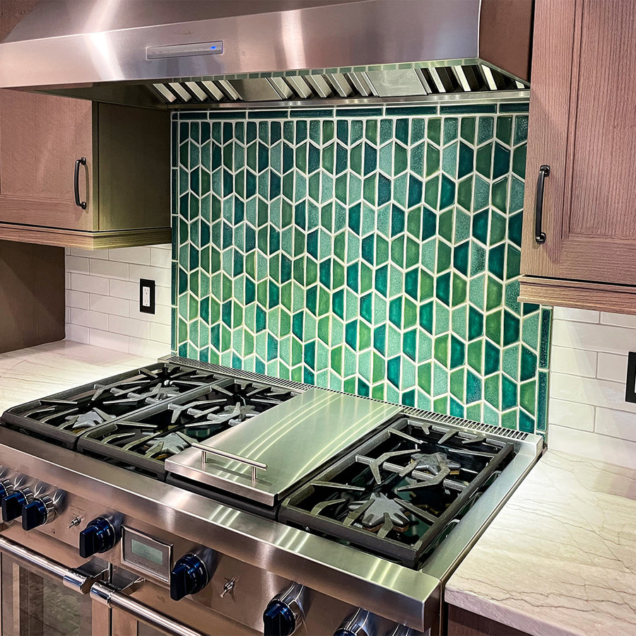 alternating green tiles in a half hexagonal pattern as part of a custom kitchen backsplash.
