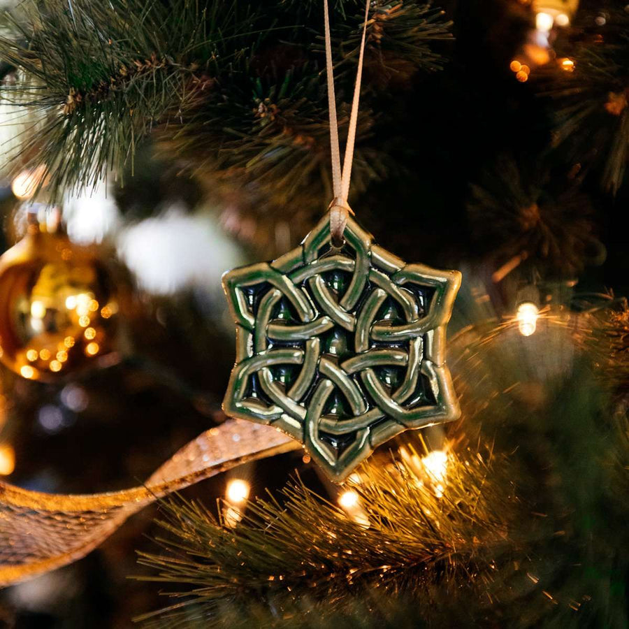 Shaped almost like a snowflake with 6 pointed corners, the Celtic Knot ornament features an intricate, winding pattern with no beginning or end. It is in our glossy deep green Kale glaze.