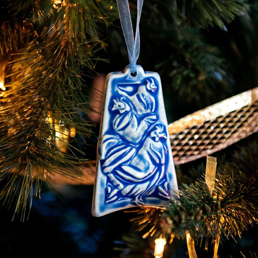 The ornament is glazed in a steel blue color with a pale blue ribbon.