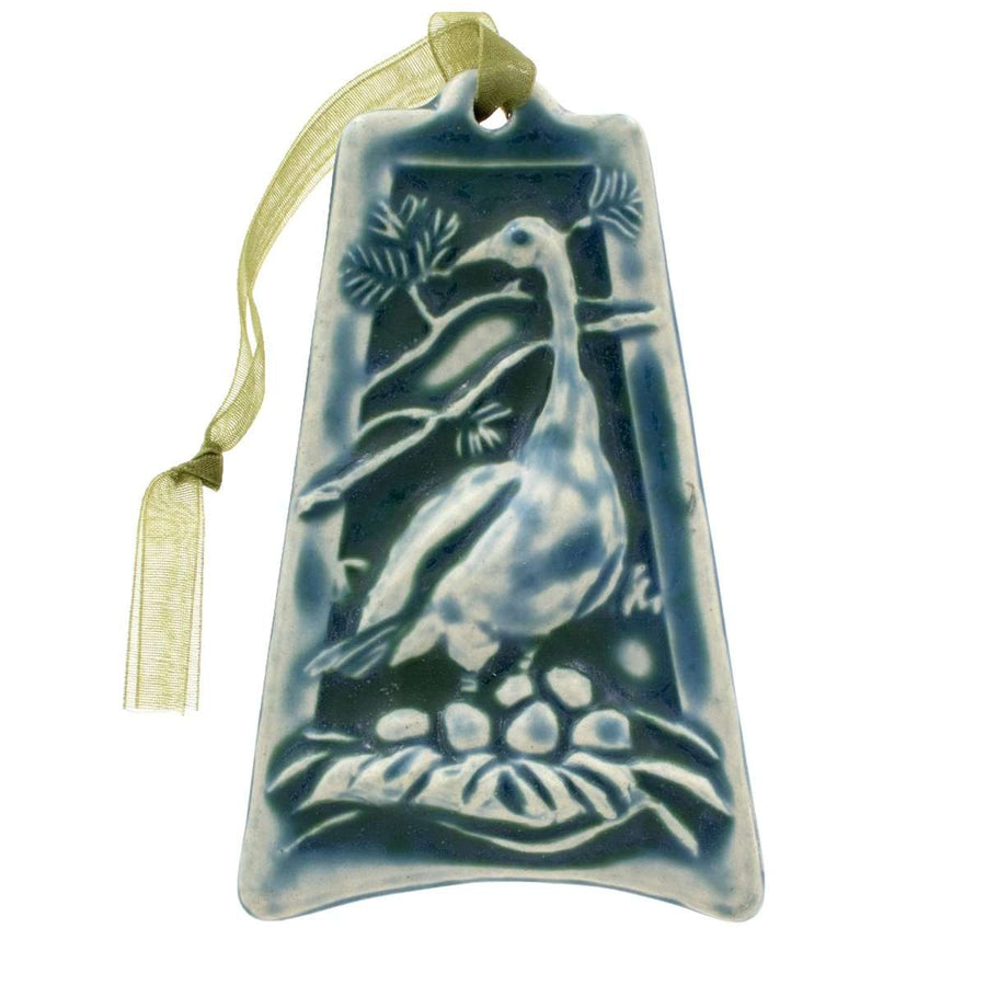 The ornament is glazed in a steel blue color with a pale green ribbon.