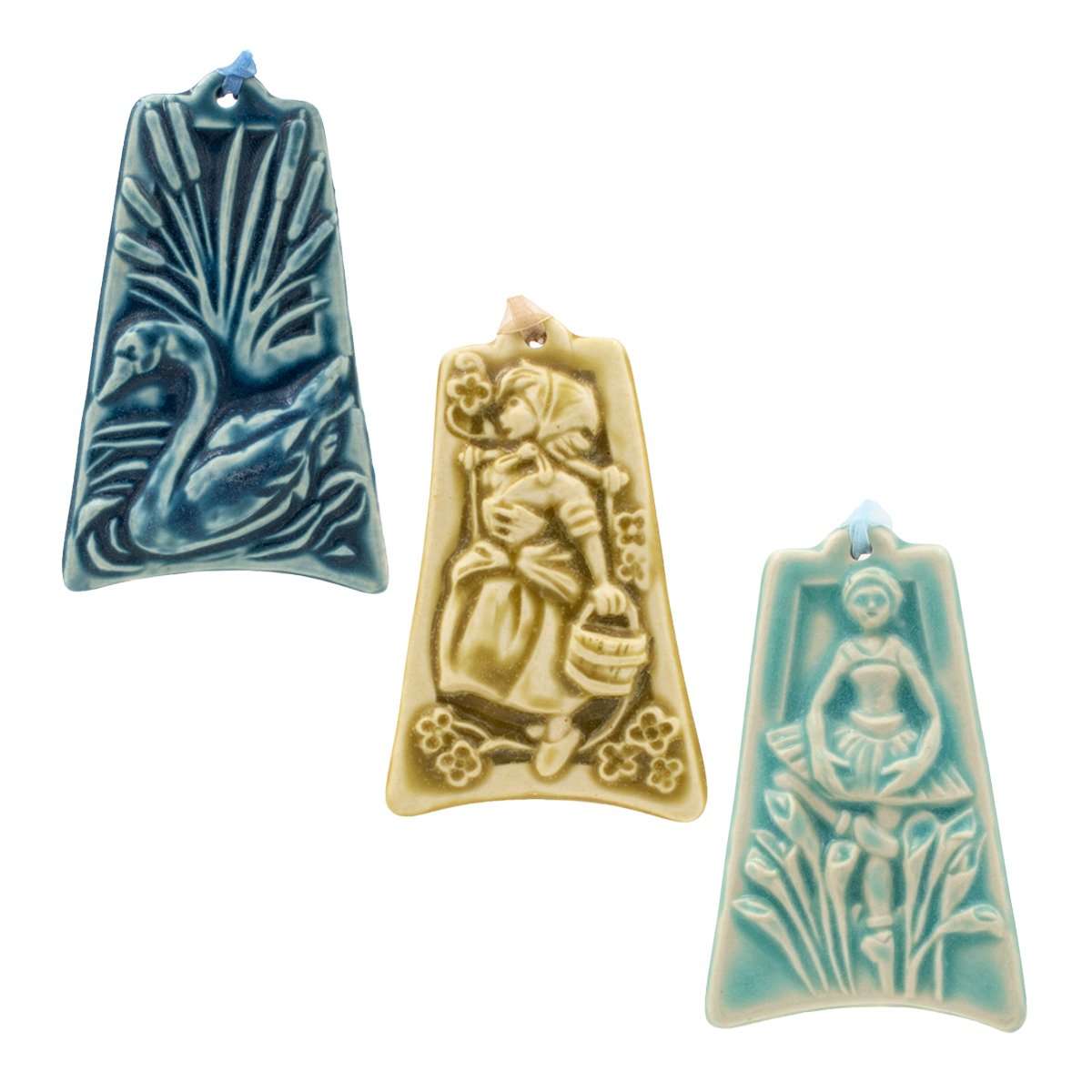 Three colorfully embossed ornaments are against a white background: one shows a swan swimming among seven cattails, another shows a young woman dressed as a milkmaid carrying a wooden bucket, the last has a ballerina mid-dance while nine calla lilies are being thrown to her.