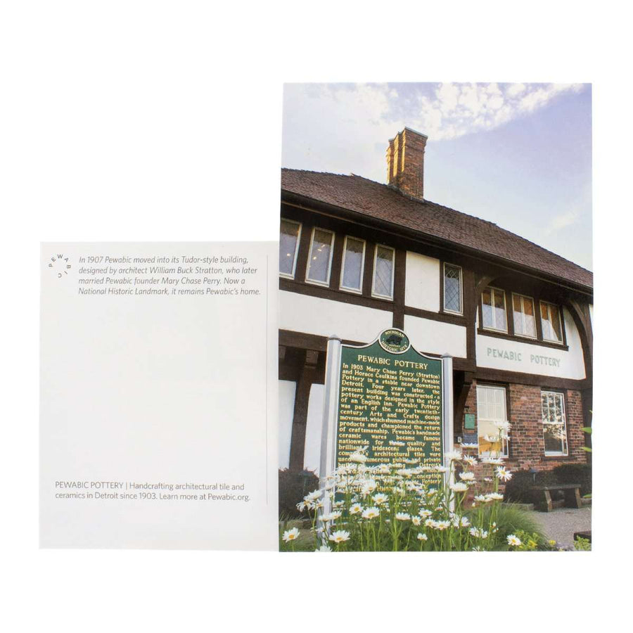 This postcard features a photo of the historic Tudor-style Pewabic building with the large green National Historic Landmark sign out front.