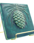 6x6 Pinecone tile rests in a 4" gold wire frame stand.