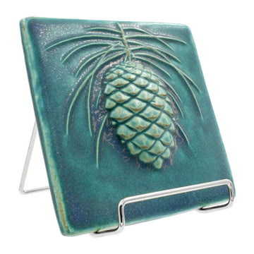 6x6 Pinecone tile rests in a 4" silver wire frame stand.
