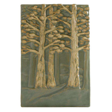 The Hillside Forest Tile features a grouping of trees- the first three are a light cream color while the trees behind them fade into a pale green, showing the perspective of a deep forest. This tile is high relief, meaning the curves and divots of the branches, leaves and tree trunks are curved and deeply set into the clay.