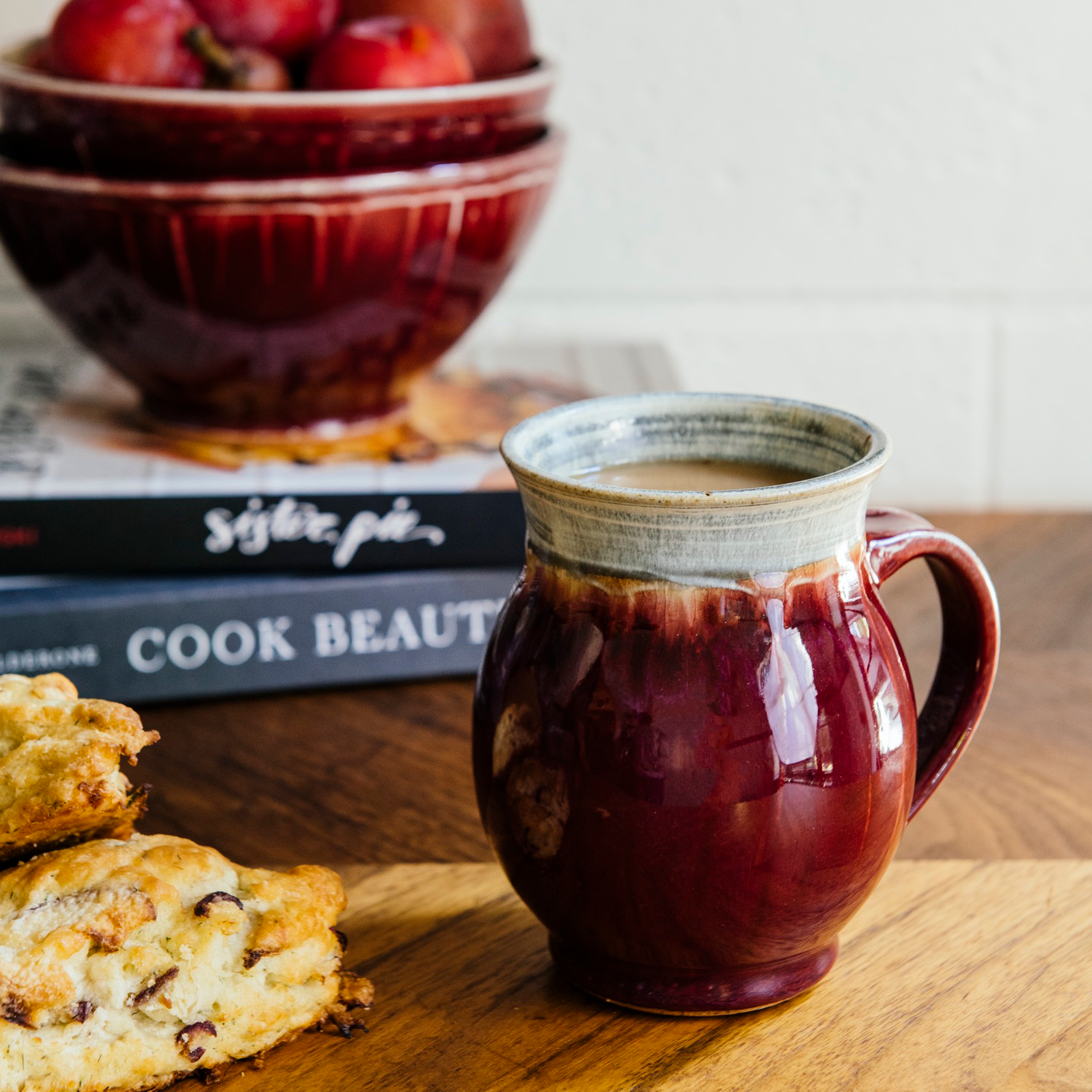 The Classic Mug is has rounded sides with a more narrow opening for drinking. The main body of the mug is the main glaze color while the inside and the lip are a coordinating color. This mug features the glossy deep red Winterberry glaze with a gray lip and interior.